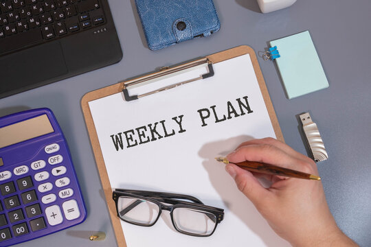 PLAN YOUR WEEK text on white paper on a bright background. gray and yellow. vacation after a hard week.
