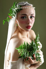 Naklejka premium Beautiful elf girl with floral decor on dark olive background