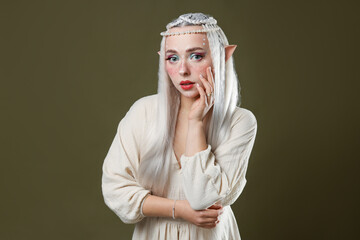 Naklejka premium Beautiful elf girl on dark olive background