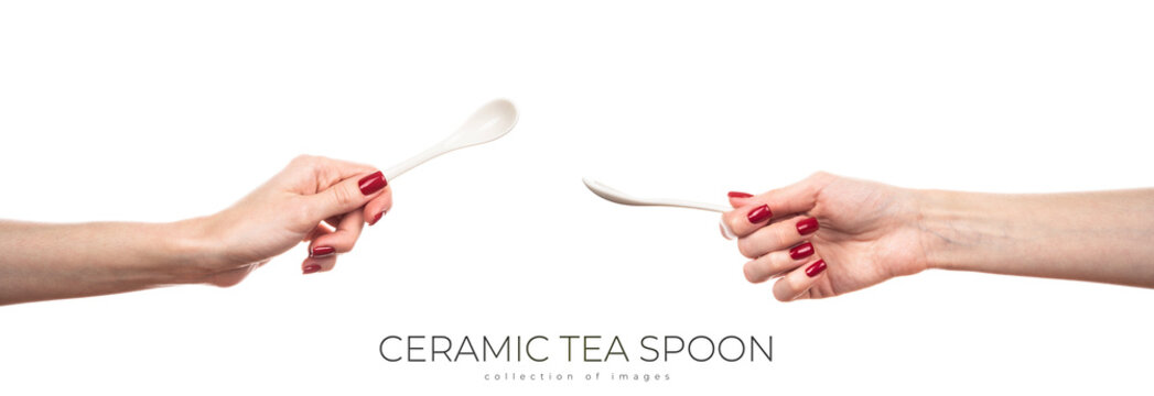 White ceramic tea spoon in female hand isolated on white background.