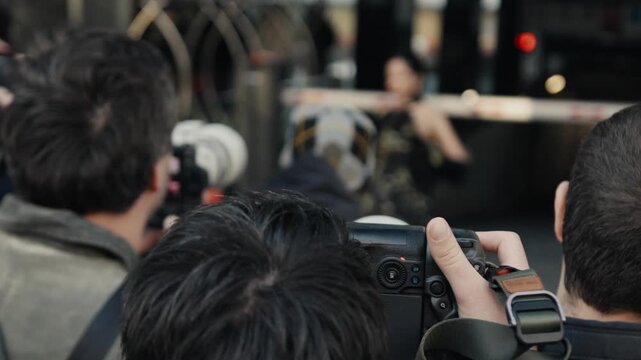 Photographers taking pictures of a celebrity on the red carpet