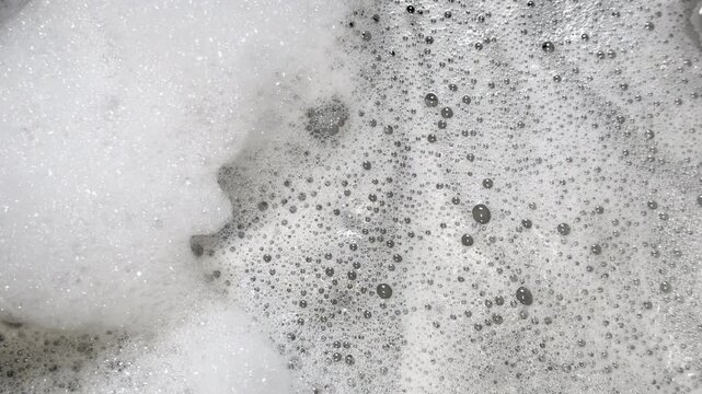 Soap suds jiggle and swirl to create organic graphic element