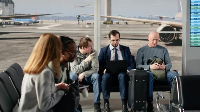 African american man in airport lounge checking departure board for timetable data. Multiracial travelers looking at flight status information on display, catching plane for holiday trips