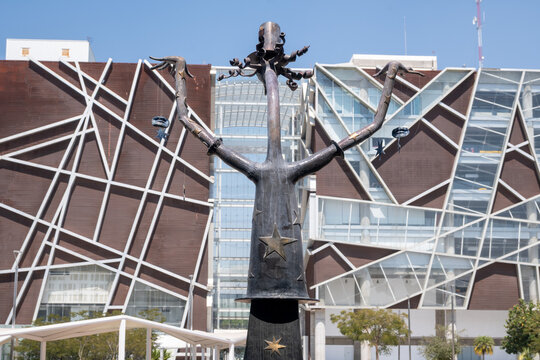Zapopan, Mexico - February 28 2026: Striking abstract metal sculpture at Bicentennial Plaza, University Cultural Center, Zapopan, against modern architecture and bright blue sky.