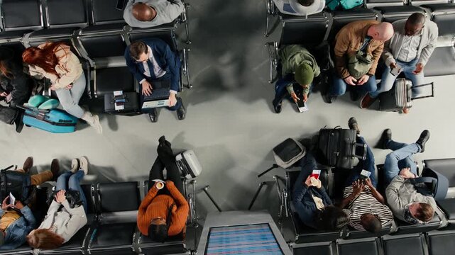 Angry people shouting and making phone calls in busy airport terminal, annoyed by flight delay, top down view. Frustrated travelers upset by flight cancelation, yelling after losing plane