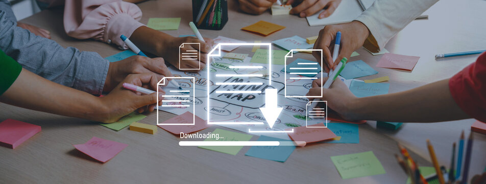 A group of individuals collaborates in an office to finalize a creative project, using sticky notes and documents while symbolizing a digital download process. Trope