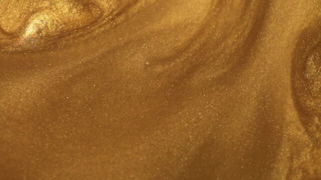 Glossy golden shimmer wallpaper. holiday glitter celebration backdrop. golden texture with swirling light reflections and glitter shine. 4k footage