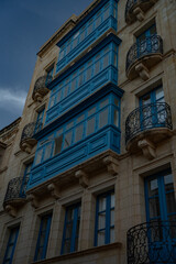 Obraz premium Epic traditional European town historic stone facade vertical panorama blue balconies. 