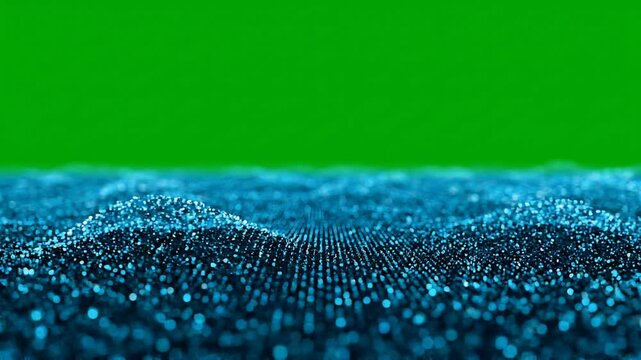 Abstract blue digital wave pattern with small particles on a green screen background, representing data visualization or futuristic technology.