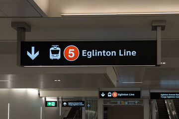 Naklejka premium Toronto, ON, Canada - May 4, 2026: A sign hanging from the ceiling at a station on Eglinton Crosstown LRT (Line 5) in Toronto, ON, Canada. The Eglinton Crosstown LRT is a new rapid transit line in Tor