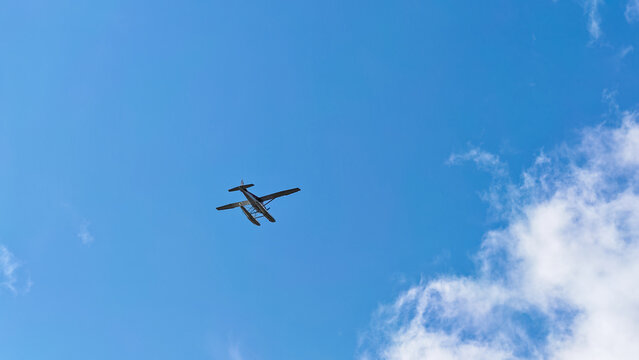 Sitka, Alaska - USA - August 3, 2024 - Seaplane Over Against a Blue Sky With Clouds
