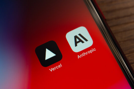 Mexico City, MEXICO - Apr 6 2026 : Close-up of an iPhone home screen showing the Vercel and Anthropic app icons side by side, on a wooden surface.
