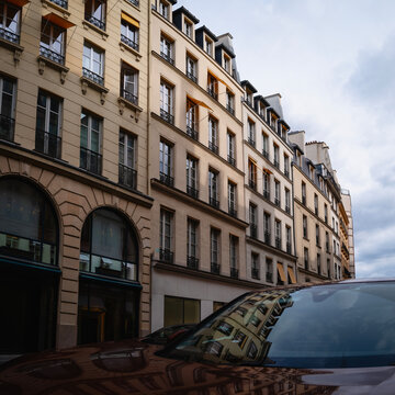 Paris, France, historic district with landmark architecture and reflection on the car hood, an abstract casual metropolitan image for background