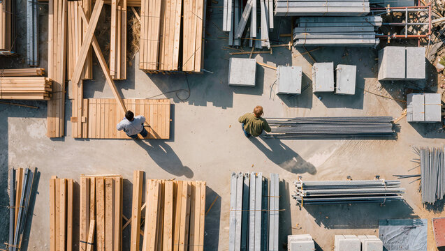 aerial lumber yard and timber materials storage, construction supply depot with wood beams from above