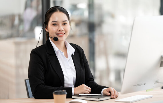 Smiling Asian Customer Support Representative with Headset in Office
