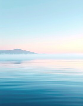Tranquil seascape at dawn with soft pastel hues painting the horizon over misty mountains and calm blue water