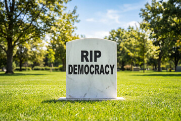 Tombstone in a cemetery with the words RIP democracy engraved on the headstone