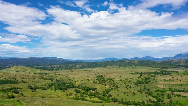 Tropical landscape: mountains with rainforest and hills with green grass.Mountains against the blue sky and clouds. Philippines, Luzon. Summer landscape.