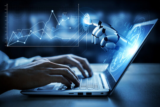 A human hand types on a laptop while a robotic hand interacts with digital data displayed on the screen. The image symbolizes the integration of human and machine capabilities in technology. Scalp