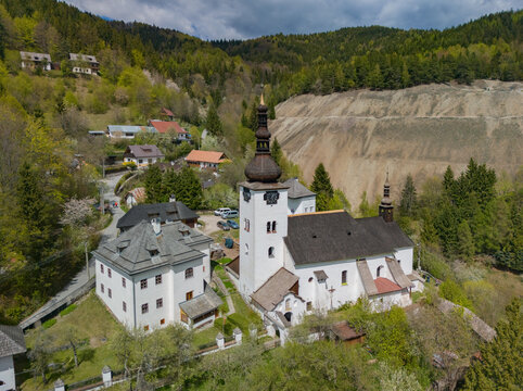 Aerial view of the historic Church of the Conversion of the Lord and traditional houses in the mountain village of Spania Dolina, Banska Bystrica Region, Slovakia.