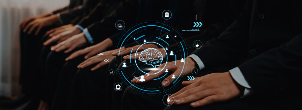 Business professionals sit together in a brainstorming session, integrating technology and creativity with a digital brain graphic, symbolizing innovation and collaboration. Trope