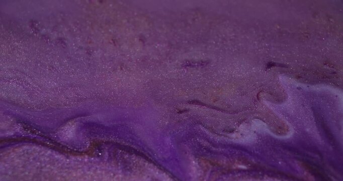 Ink splatter. Spill texture. Defocused purple orange color blend glitter bubbles acrylic liquid floating on abstract creative background.