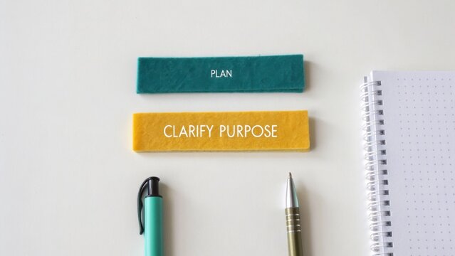Two Felt Strips Labeled 'PLAN' and 'CLARIFY PURPOSE' Above Two Pens on a White Background