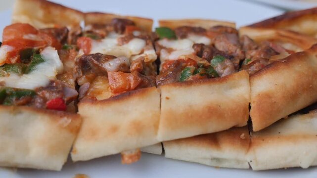 Close-up of Sliced Turkish Pide with Meat and Melted Cheese