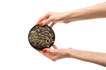 Naklejka premium Female hand sunflower seeds on a white background isolation
