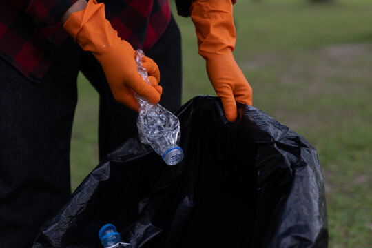 Volunteers collecting plastic waste in nature during environmental cleanup, promoting sustainability, conservation, teamwork, and community responsibility for protecting the planet.
