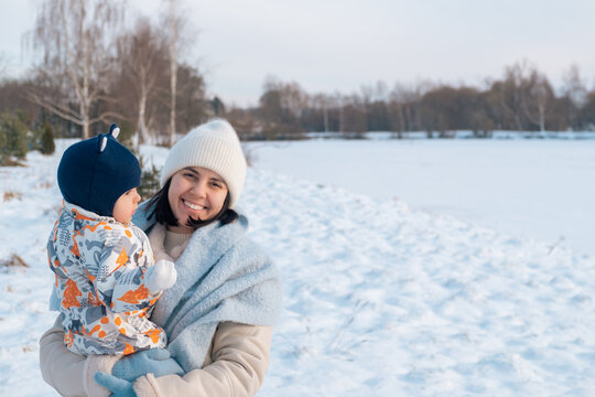Smiling Mother and Baby Enjoying a Winter Day