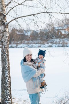 Smiling Mother and Baby Enjoying a Winter Day