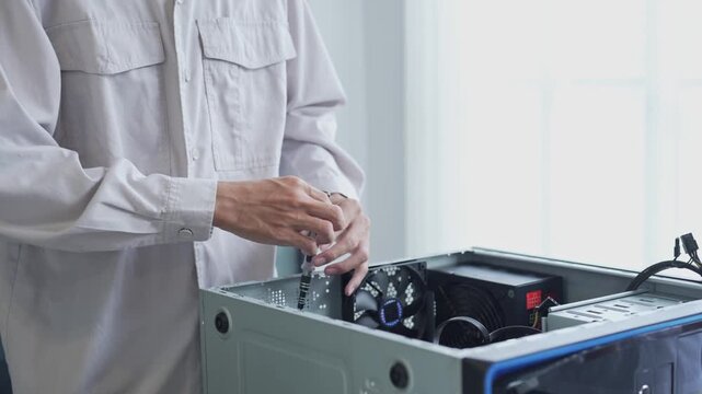 Asian man using screwdriver maintenance computer