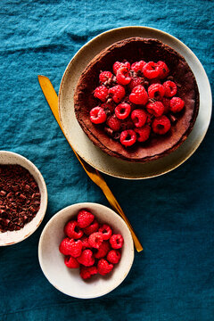 Chocolate Basque Cheesecake with Raspberries and Chocolate on Blue Linen Tablecloth