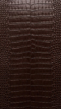 Dark brown crocodile leather texture background with scaly pattern