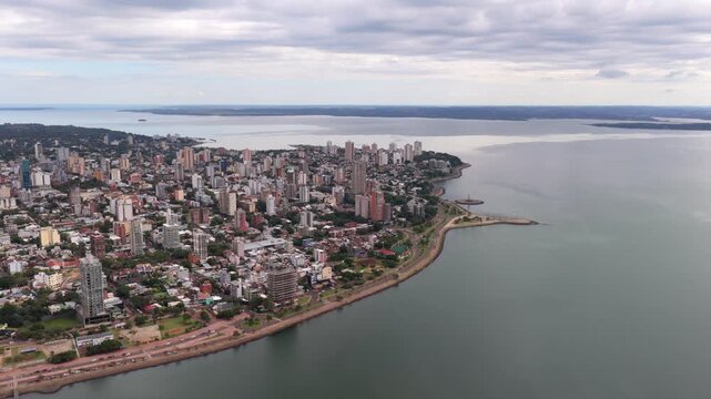 Aerial View of Posadas City Skyline Along the Paran&aacute; River Under Cloudy Skies
