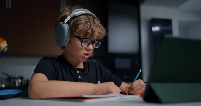 An Energetic Young Boy Explains Ideas With Gestures In Warmly Lit Home Learning Environment