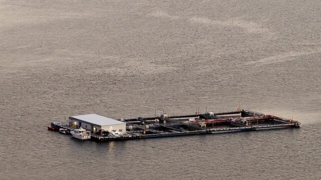 Polar night drone view of cod farm mariculture facility in Ringvassoya fjord