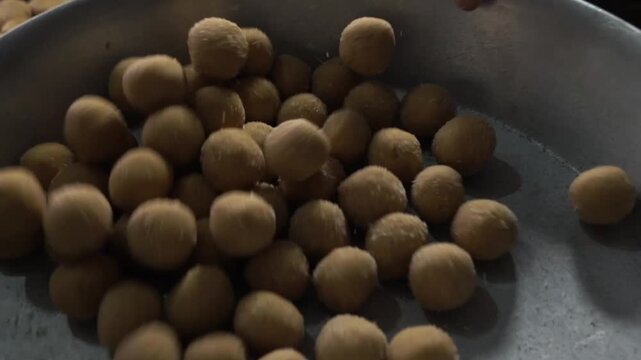 Close up shot of traditional besan ladoo served in thal. Homemade besan ladoo showcasing festive Indian dessert.