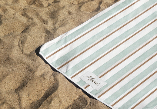 Striped Towel Mockup On Sandy Beach PSD