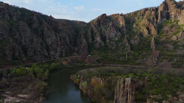 Experience breathtaking landscapes along the Arda River near Madzharovo, Bulgaria. Witness the lush greenery, towering cliffs, and tranquil waters that define this picturesque travel destination.
