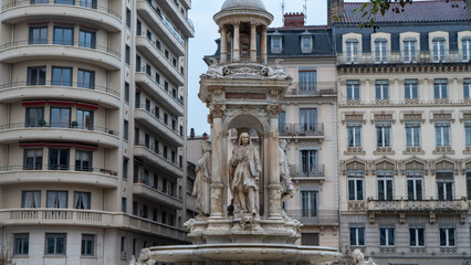 Baroque Fountain with Statue in Place des Jacobins, Lyon, France Surrounded by Historic Buildings © daniele