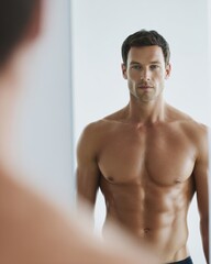 Obraz premium Man checking body progress in mirror fitness