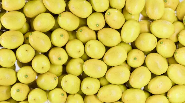 Ripe yellow lemons collide in slow motion, highlighting juicy citrus texture and freshness. Close-up of vibrant fruit motion, perfect for natural food and healthy lifestyle concepts.