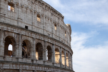 Obraz premium Colosseum arches detail in Rome, Italy with soft sky, ancient Roman architecture
