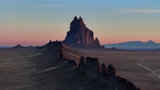 Drone view of Shiprock, a well-known Southwest landmark, surrounded by vast desert terrain and open skies, ideal for travel and destination storytelling