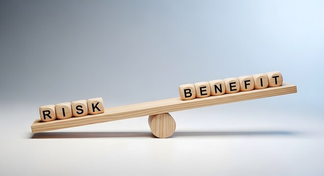 Risk and benefit balance concept. Wooden seesaw scale balancing wooden cubes with words risk and benefit showing decision making strategy.