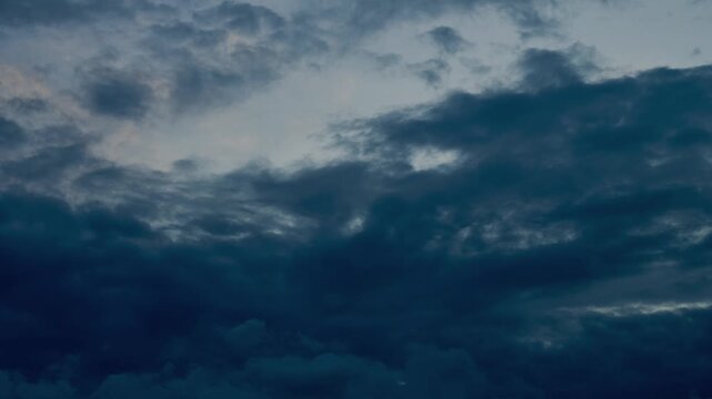 Ominous dark storm clouds moving across evening sky