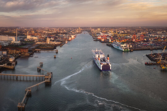 Aerial view of Dublin Port with a large ferry navigating the channel towards the city skyline under a golden sunset Dublin, County Dublin, Ireland.