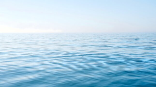 Calm and Peaceful Blue Water Serene Ocean Waves Under a Hazy Sky